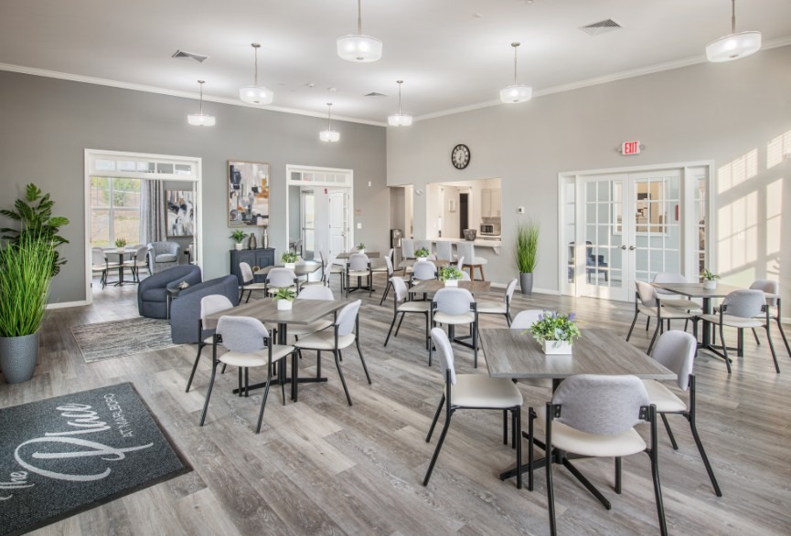 Bright, modern communal area featuring tables,