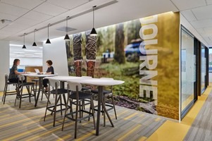 Two women collaborate at a modern office workspace