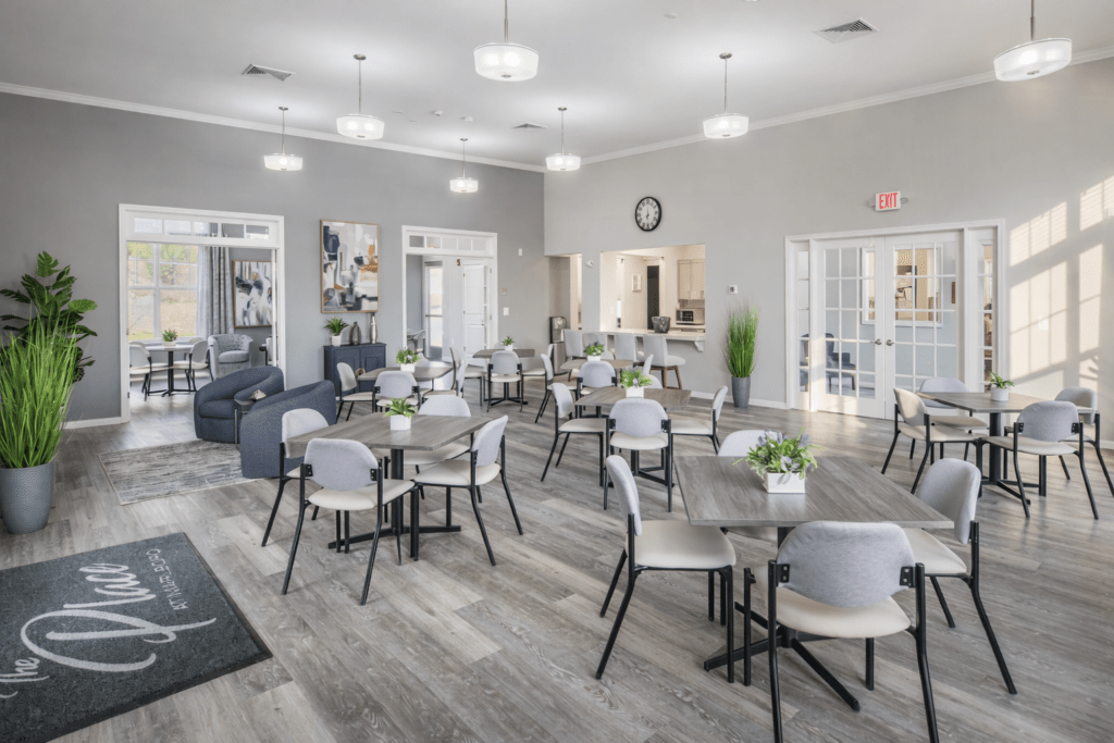 Bright, modern communal area featuring tables,